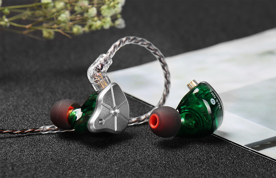 Close up of green TRN STM earphone